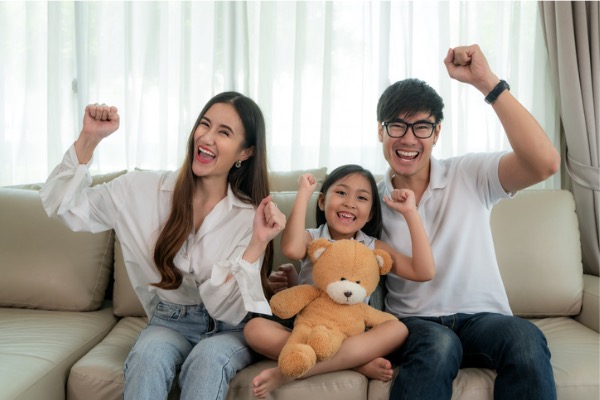 Family cheering on couch 